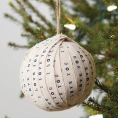 a white ornament hanging from a christmas tree