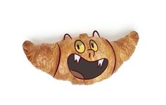 a croissant shaped like an animal with its mouth open and eyes wide open