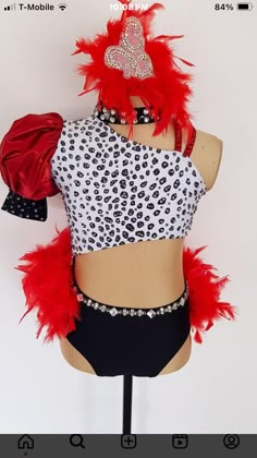 a female mannequin with red feathers on it's head and leopard print top