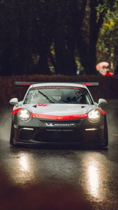 a car driving down a wet road in the rain