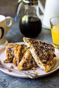 three pieces of french toast on a plate next to a glass of orange juice and coffee