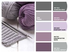 some yarn and knitting needles on a table with color swatches for the colors purple, gray, and white