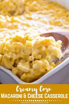 macaroni and cheese is being scooped from a casserole dish with a wooden spoon