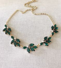 a necklace with green and white stones on it