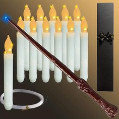 a harry potter wand is next to some white candles