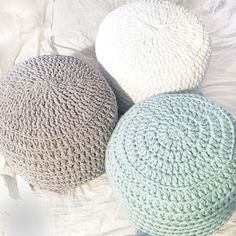 three crocheted round poufs on a bed with the price $ 15