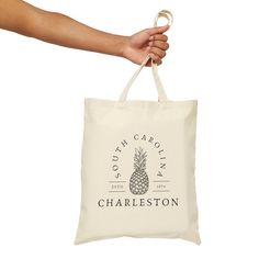 CHARLESTON SOUTH CAROLINA TOTE BAG Carry a piece of Charleston's charm with you wherever you go with our Charleston shopping tote. Crafted from high-quality canvas, this tote bag combines durability with timeless style and has ample space that's perfect for stashing your sunscreen, shades, or all sorts of Charleston souvenirs. The reinforced stitching ensures durability, so you can rely on it for years to come. Need a little reminder of your favorite city or a thoughtful gift for a fellow Charle Eco-friendly Ink Canvas Tote Bag For Travel, Eco-friendly Travel Canvas Bag, Eco-friendly Canvas Travel Bag, Charleston Shopping, Beach Necessities, Plant Aesthetic, Custom Tote Bags, Easily Distracted, Charleston South Carolina