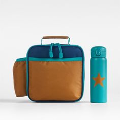 A fun and functional lunch box that's built to handle all the thrills and spills of the day. Combining colorblocks of navy and ocher with pops of aqua trim, our bag is constructed of food-safe and supremely durable polyester made from recycled water bottles. It's also lightweight and easy to clean, plus roomy enough to hold multiple storage containers. An insulated lining keeps meals just the way your kid likes them—hot, cold or somewhere in between. An outer pocket safely stows a napkin, utensi Blue Lunch Bag For Back To School, Functional Blue Rectangular Lunch Bag, Blue Functional Lunch Bag For Back To School, Functional Blue Lunch Box For School, Blue Rectangular Lunch Box For Outdoor Activities, Blue Rectangular Lunch Box For Back To School, Back To School Rectangular Lunch Box For Outdoor Activities, Playful Blue Lunch Box For Daycare, Rectangular Lunch Box For Back To School