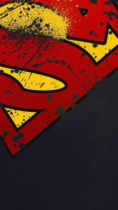 the superman symbol is painted on to a black t - shirt with yellow and red splatters