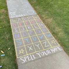 a sidewalk that has chalk writing on it