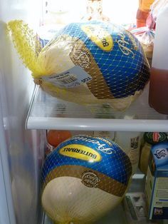 there are two large balls in the refrigerator, one is blue and yellow with gold on it