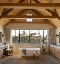 a bathroom with a large tub and wooden ceiling