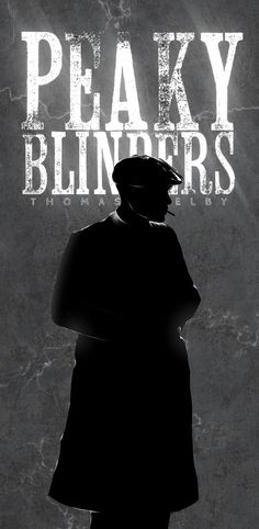 a man standing in front of a wall with the words peaky blinders on it