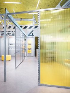 the inside of a building with yellow walls and metal partitions to divide it from other rooms