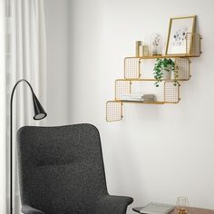 a living room with a chair, coffee table and bookshelf on the wall