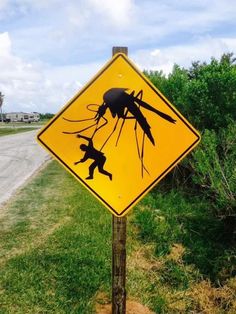 a street sign that has been altered to look like an image of a mosquito crossing the road