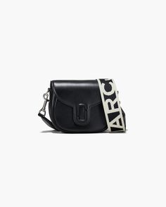 A coveted addition to our leathers, this small saddle bag is a new style for the J Marc collection. It's crafted from luxurious leather, secures with a magnetic snap closure, has an interior slip pocket for organization, comes with a complimentary webbing logo strap, and is finished with a leather covered J Marc hardware at front. | MARC JACOBS The Covered J Marc Saddle Bag in Black Marc Jacobs Crossbody Bag, Leather Billfold, Bag Women Fashion, Leather Saddle Bags, Sack Bag, Small Tote Bag, Marc Jacobs Bag, Small Tote, Saddle Bag