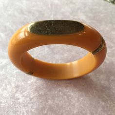 Awesome Vintage Bakelite Bangle Bracelet, Butterscotch color with beautiful original brass banding and oval brass plates. These plates could be monogrammed. Some minor scratching on the plates, could be polished out, I will leave that to the new owner. Standard 2.5 inch opening, the bracelet is almost 1/2 inch wide at the thickest part the oval brass plate is 1.5 X 0.5 inches. The bracelet is 3/4 inch wide. This is in beautiful vintage condition, see all photos. Very unusual to find one like thi Adjustable Oval Bangle With Polished Finish, Vintage Bangle Bracelet With Polished Finish, Vintage Oval Cuff Bracelet With Polished Finish, Vintage Bangle Bracelets With Polished Finish, Vintage Orange Bangle Bracelets, Vintage Bangle With Polished Finish, Retro Adjustable Gold Bangle, Adjustable Retro Gold Bangle, Vintage Adjustable Bangle With Polished Finish