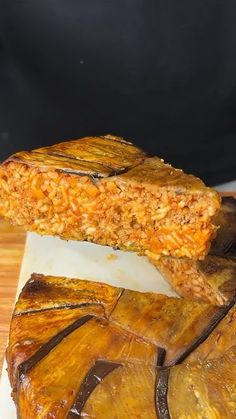 two pieces of food sitting on top of a cutting board