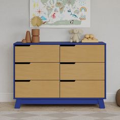 a blue and wooden dresser in a room with a map on the wall above it