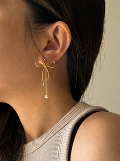 - BOWE II -  Embrace modern elegance with a twist in our new bow earrings! 🌟 The bow + dangle mini pearl drop combination is so unique - a nice blend of chic, cute, and minimalistic style. You can also choose to just have the bow on its own! Handcrafted with love and high-quality 14k gold-filled accents, these dainty earrings are made for durability and keeping sensitive skin in mind!✨ ♥ 3 style options♥  - Bow with regular back (no pearl) - Bow with the pearl dangle back - Bow with both backs (so you can wear them two-way!) //Materials// *  14k Gold Filled Bow & Gold Vermeil Post (Gold on silver) *  Freshwater natural pearls //Dimension// * Bow length: 3.3cm * Bow width: 2.8cm * Pearl drop: 4.5cm * Pearl diameter: ~3mm **Feel free to ask me anything if you have doubts //Freshwater Pearls Elegant Butterfly Knot Jewelry For Wedding, Elegant Rose Gold Earrings With Bow, Elegant Rose Gold Bow Earrings, Elegant Evening Jewelry With Butterfly Knot, Elegant Butterfly Knot Earrings For Wedding, Yellow Gold Bow Earrings For Wedding, Elegant Wedding Earrings With Butterfly Knot, Elegant Butterfly Knot Earrings For Formal Occasions, Elegant Butterfly Knot Jewelry For Party