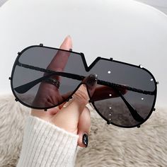 Elevate your style to bold new heights with our Luxuria Oversized Sunglasses . Designed for the fashion-forward, these sunglasses blend high-fashion design with everyday wearability. Each pair boasts an oversized, unique V-cut lens that sets you apart from the crowd, while the studded detailing adds a touch of edgy sophistication. The lightweight frames ensure comfort for all-day wear, while the UV400 lenses provide your eyes with 100% protection against the sun’s harmful rays. Choose from classic tawny hues that compliment any outfit or make a statement with our selective color palette ranging from deep burgundy to vibrant yellow. Whether you’re running errands, heading to a chic café, or lounging by the pool, the Luxuria Sunglasses are your perfect companion, marrying protection with run Chic Glass Shield Sunglasses With Uv Protection, Modern Shield Sunglasses For Spring Party, Chic Shield Sunglasses With Tinted Lenses, Trendy Polarized Glass Shield Sunglasses, Modern Aviator Sunglasses With Uv Protection For Party, Chic Glass Shield Sunglasses For Spring, Chic Anti-reflective Glass Shield Sunglasses, Trendy Black Glass Shield Sunglasses, Modern Sunglasses With Mirrored Lenses For Fashion