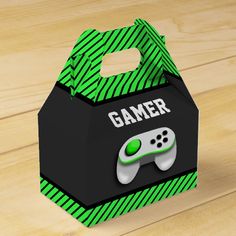 a green and black box with a video game controller on the lid that says gamer