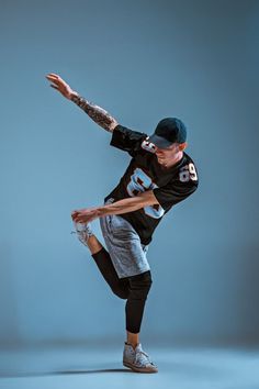 a man in black shirt and grey pants doing a trick