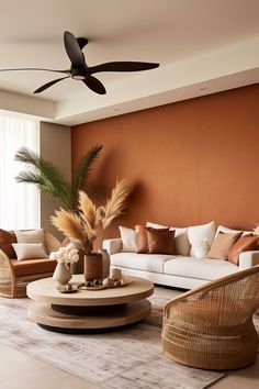 a living room filled with lots of furniture and a ceiling fan in the middle of it