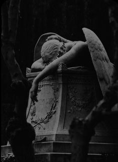 a black and white photo of an angel statue