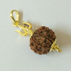 RUDRAKSHA BEADS SIZE - 15 MM  ORIGIN - NEPAL PENDENT MADE IN ASTHADHATHU METAL (MIXTURE OF EIGHT METAL ) WITH 24 CARAT GOLD PLATING FIVE FACED MUKHI RUDRAKSHA 5 mukhi Rudraksha represents Lord "Rudra Kalagni" which symbolizes the 5 forms of Lord Shiva. This auspicious rudaksha helps awaken one's higher self means "Upa Guru" and through that to God.  Hence it is the most widely worn bead by students and sages since ancient times.  The planet associated with 5 mukhi rudraksha is Jupiter. Hence, 5 Rudraksha Jewelry For Men, Rudraksha Jewelry, Yellow Gold Mens Rings, Black Beads Mangalsutra, Black Beads Mangalsutra Design, Rudraksha Beads, Mangalsutra Designs, Gold Bridal Jewellery Sets, Diamond Necklace Designs