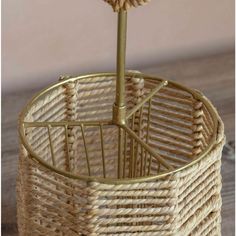 a wicker basket with a flower in it