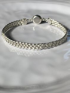 "This attractive bracelet is handwoven with sterling silver wire and finished with sterling silver end caps and secure magnetic clasp. Bracelet is approximately 1/4\" wide and will be made to fit your wrist size.   You can give me your wrist measurement and indicate the fit you prefer: snug or some wiggle room. Or you can just indicate small (6.5\"), medium (7.0\"), large (7.5\") xlarge (7.75\").   Thank you for looking in!" Silver Sterling Braided Bracelets, Braided Sterling Silver Bracelet, Elegant Braided Sterling Silver Bracelet, Elegant Sterling Silver Braided Bracelet, Classic Adjustable Braided Bracelet With Lobster Clasp, Classic Silver Adjustable Braided Bracelets, Elegant Braided Sterling Silver Bracelet Gift, Elegant Braided Sterling Silver Jewelry, Handmade Classic Sterling Silver Braided Bracelets