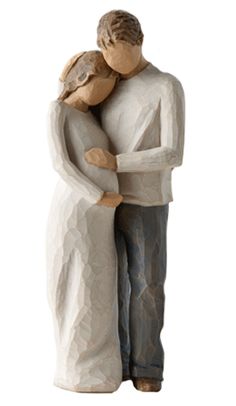 a ceramic figurine of a man and woman holding each other