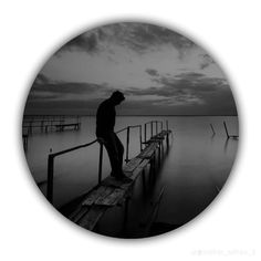 a man standing on top of a wooden pier