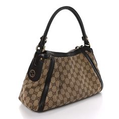 This is an authentic GUCCI Monogram Small Scarlett Studded Interlocking G Hobo in Dark Brown. This chic hobo is crafted of Gucci GG monogram fabric with brown leather trim. The bag features a broad looping rolled leather top handle with shiny gold ring links and leather trim across the face and top rim. The zipper opens to a coarse linen fabric interior with a zipper pocket. This handbag has room for your essentials for day or evening with the one of a kind style of Gucci! Gg Monogram, Gucci Monogram, Leather Top, Leather Trim, Leather Trims, Gucci Bag, Linen Fabric, Top Handle, Gold Ring