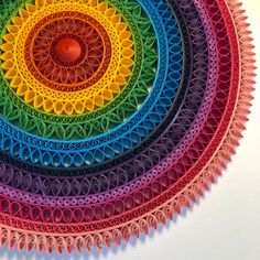 a multicolored circular artwork made with crochet