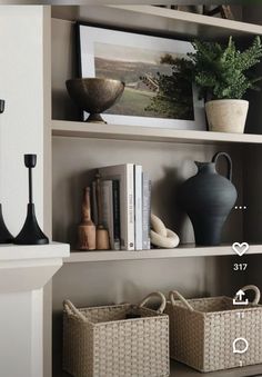 the shelves are filled with vases, books and other decorative items in baskets on them