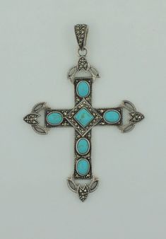 Beautiful vintage 1960s handmade sterling silver oval and square shaped cabochon natural turquoise and round cut natural marcasite cross. Beautiful gift for a loved one! The pendant length approx. 2.94 inches and approx. 3.35 inches with the bail. Pendant width approx.: 2.3 inches Pendant weight approx.: 26.9g Total turquoise weight approx.: 3.00 ct. Hallmarks: 925 THAI Will be placed into a suitable gift box Free shipping within the U.S. Vintage Oval Marcasite Jewelry, Silver Cross Jewelry With Natural Stones, Elegant Turquoise Cross Jewelry, Turquoise Jewelry Native American, Natural Turquoise, Handmade Sterling Silver, Vintage 1960s, Turquoise Jewelry, Round Cut