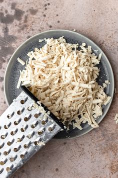 a grater with shredded cheese on top of it