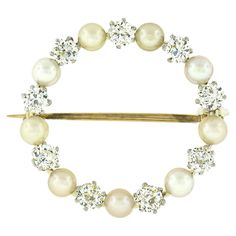 This absolutely gorgeous antique brooch was crafted during the Edwardian era from solid 18k yellow gold and platinum. It features an incredible circle of pearls and diamonds that alternate throughout its simple circular wreath design. The beautiful pearls are well matched in size at approximately 3.6-3.7mm each and have a nice white body color with golden overtones and excellent luster granting a super attractive look. From our educated opinion these pearls appear to be natural. They are wonderf Circle Wreath, The Edwardian Era, Antique Brooches, Edwardian Era, European Cut Diamonds, Wreath Designs, Body Color, Body Colour, Gold Platinum