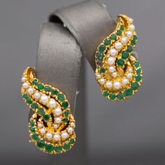 "Gorgeous Green Emerald and Seed Pearl Earrings in 22k Yellow Gold, Indian Wedding Jewelry, Kundun These gorgeous green earrings are a perfect addition to any special occasion!  The earrings are crafted in 22k yellow gold (and stamped 22k), setting off beautifully against the green of the emeralds and the white glow of the seed pearls.  The total emerald carat weight is approximately 0.60cttw.  The earrings measure 1\" in length and are just over 1/2\" across in width.  They close with omega bac Elegant Green Earrings For Reception, Elegant 22k Gold Earrings For Reception, Elegant Green Bridal Earrings For Reception, Luxury Green Earrings For Wedding, Luxury Green Wedding Earrings, 22k Gold Green Jewelry For Anniversary, Green 22k Gold Jewelry For Anniversary, Elegant 22k Gold Bridal Earrings For Anniversary, Exquisite Emerald Earrings For Wedding