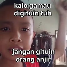 a young boy is holding up his hand in the air with words above him that read, kalo gamau digitin tuh