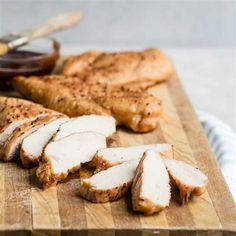 sliced chicken on a cutting board with sauce