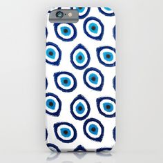 an iphone case with blue and white circles on the back, in front of a white background