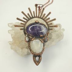 was $120AU now $70AU This creation features Amethyst, moonstone and clear quartz, beautiful gifts from God 😍 The pendant has been electroformed in copper and antiqued giving it that ancient feel.  *Please let me know if you would like to see a picture of how it looks on. Shipping includes tracking What is electroforming? Electroforming is a 4-24 hour meto-forming process that forms a layer of copper onto a conductive surface. This method allow me to create beautiful pieces that highlight the na Spiritual Silver Crystal Necklace With Copper, Bohemian Amethyst Moon Phase Jewelry, Handmade Celestial Amethyst Necklace, Mystical Silver-plated Copper Necklace, Mystical Silver-color Copper Necklace, Mystical Silver-colored Copper Necklace, Bohemian Moon Phase Copper Jewelry, Bronze Mystical Necklace For Healing, Mystical Bronze Necklace For Healing