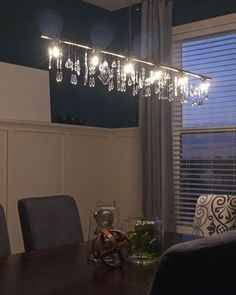 a chandelier hanging over a dining room table