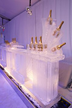 an ice bar with champagne bottles on it