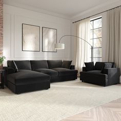 a living room filled with black furniture next to a window