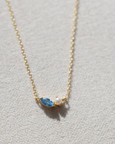 Crafted with 14k gold vermeil, this dainty necklace features a beautiful pearl paired with an ocean blue gemstone. The adjustable design allows for a perfect fit, making it a versatile and timeless piece for any occasion.  measures 16" at longest, 14" at shortest Blue Aesthetic Accessories, Gold Necklace Stack, Blue And Gold Necklace, Ocean Inspired Jewelry, Necklace Stack, Ocean Necklace, Preppy Jewelry, Pretty Jewelry Necklaces, Coastal Granddaughter